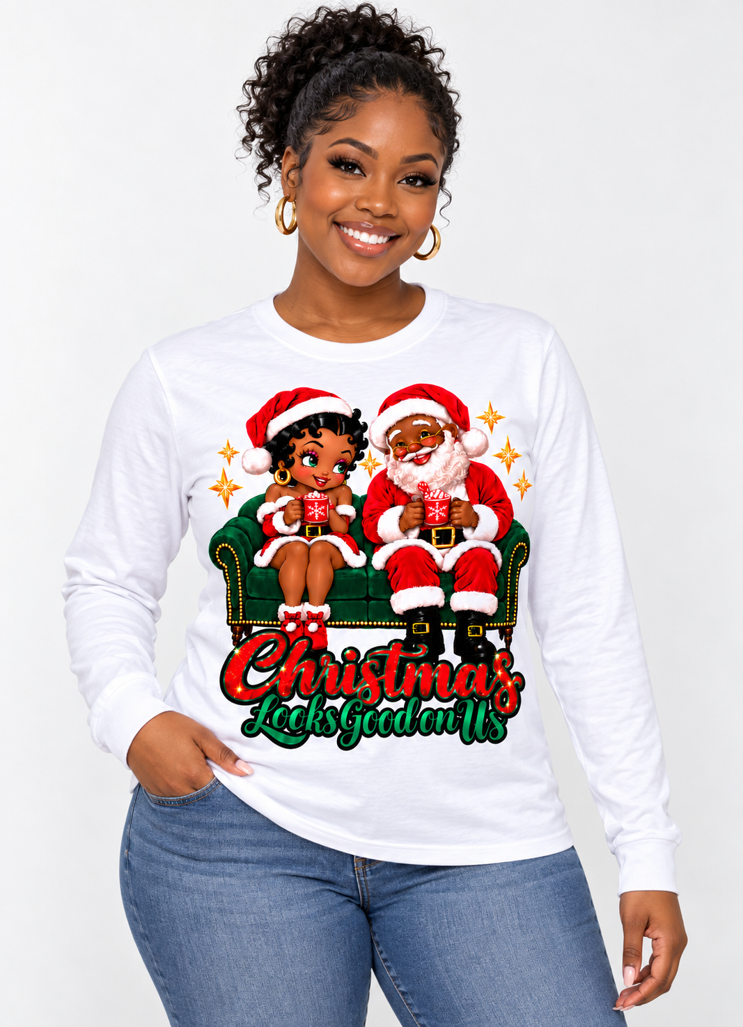 Black woman with curly updo modeling a white Christmas long sleeve shirt with Black Betty Boop and Black Santa