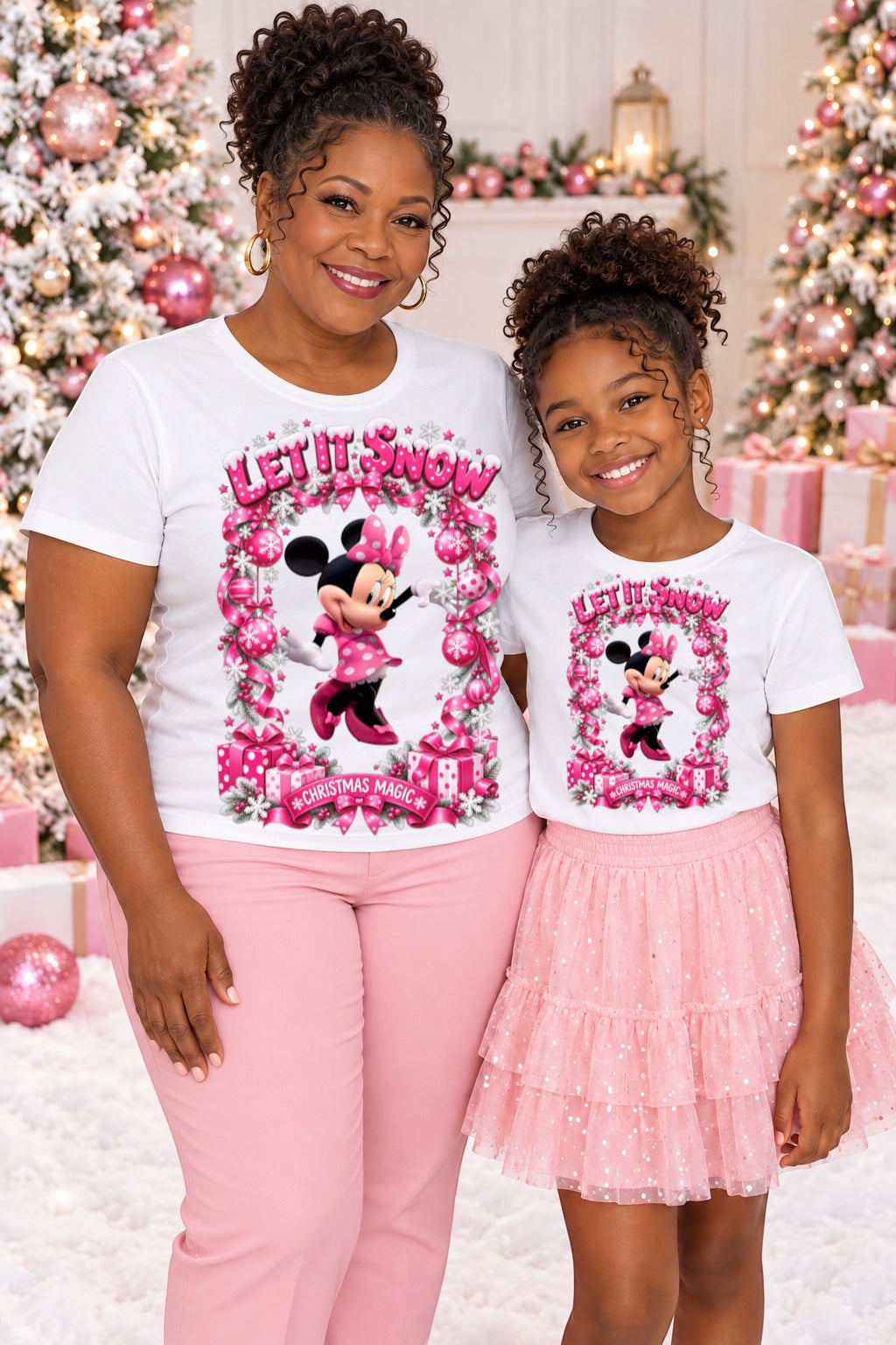 Woman and girl wearing white Let It Snow Christmas Magic shirts
